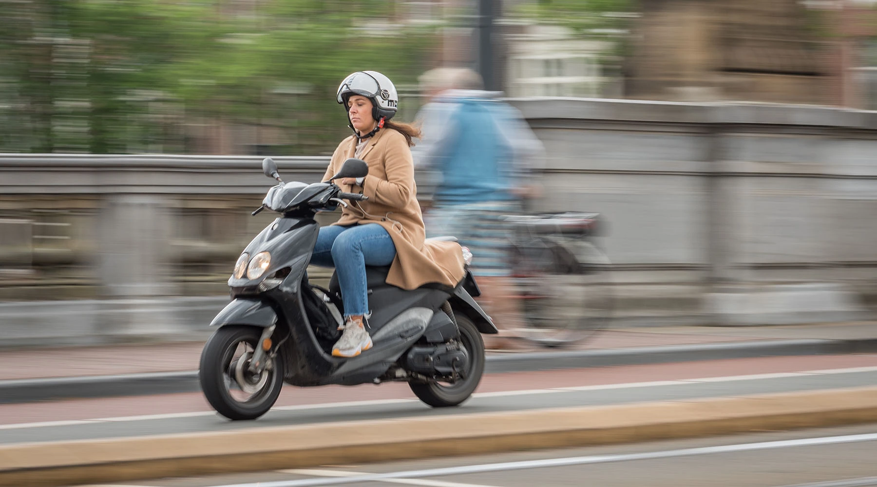 Scooter rider navigating through Amsterdam streets